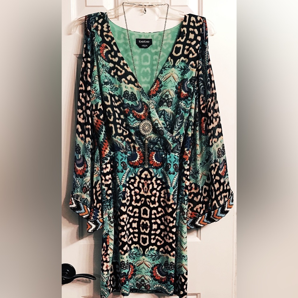 Bebe Dress with beautiful colors and bell sleeves with heavy beading.